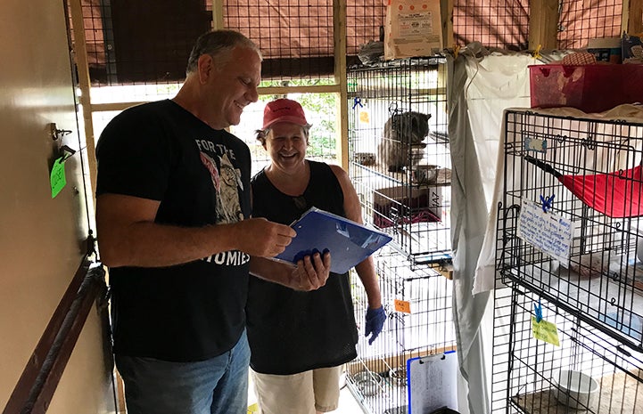 Tom Hubric and Ava looking at barn cat charts