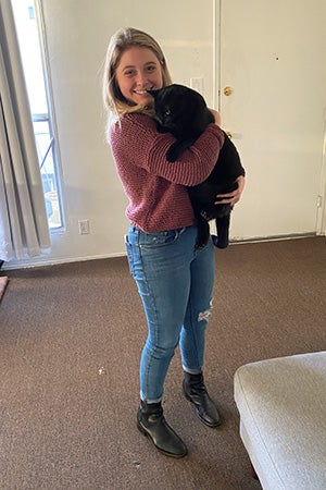 Woman holding Kent the black cat