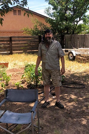 William standing in front of a house