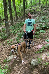 Man walking in the woods with Malcolm the dog