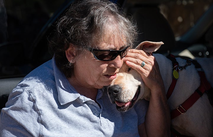 Woman cuddling Yuma the dog