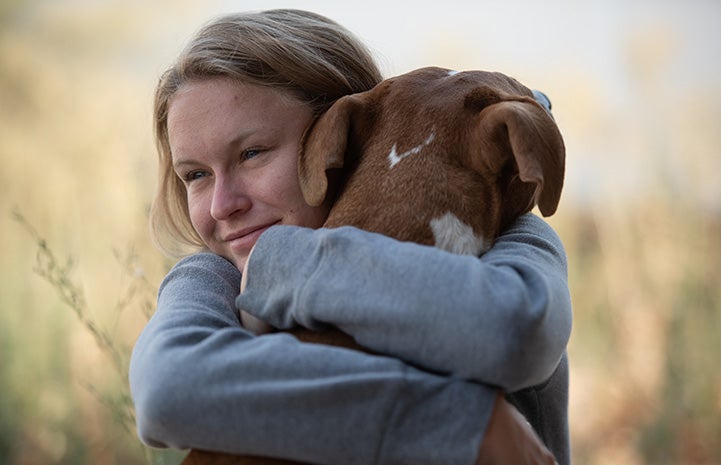 Woman hugging Guy the dog