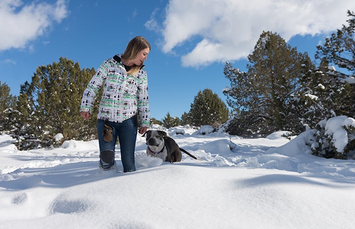 Tierney with Jango the dog walking in the snow