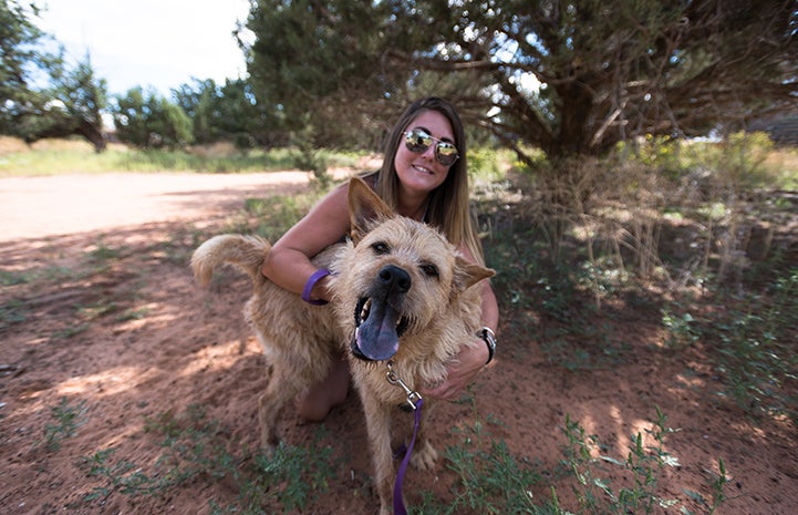 Tierney wearing sunglasses behind Wally the terrier mix dog