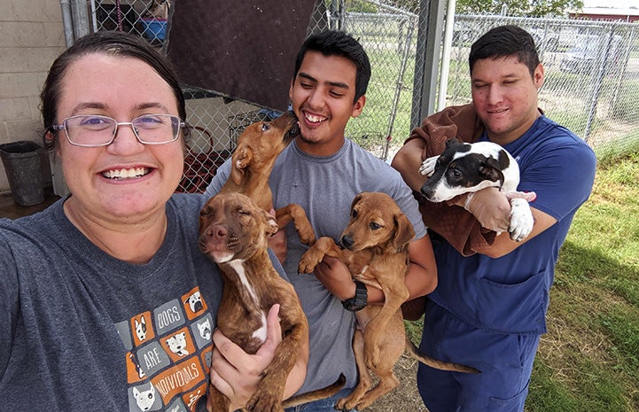 Terran, Joey and Jason holding puppies