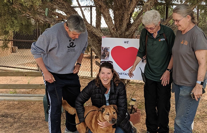 Spartacus the dog posting with a group of people