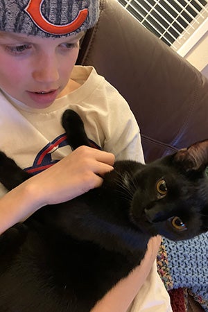 Lucas snuggling with VGK the kitten