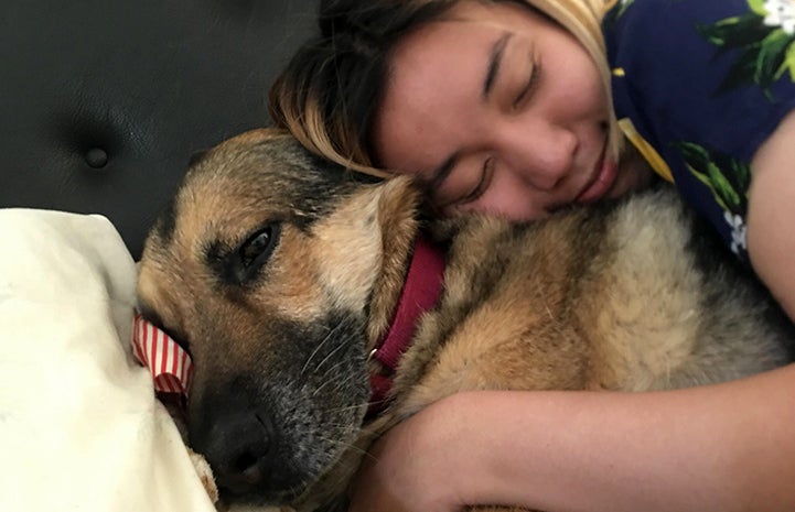 Cheryl Chan hugging her newly adopted German shepherd Harriet