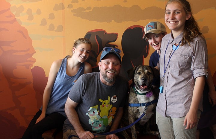 Jen, Bryan, Ashley and Maddy posting for a photo at the Best Friends Visitor's Center with a dog