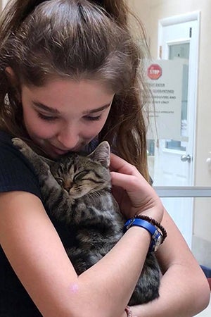 Mariah holding Cedar the kitten