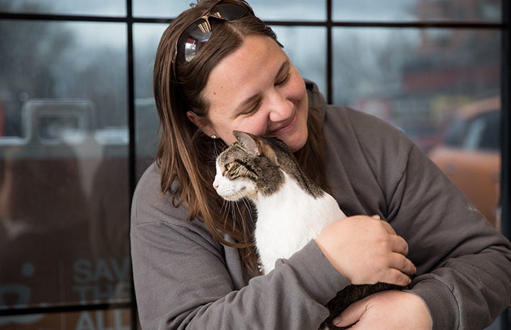 Megan snuggling with Lennox the cat after their reunion at the Best Friends Lifesaving Center in Salt Lake City