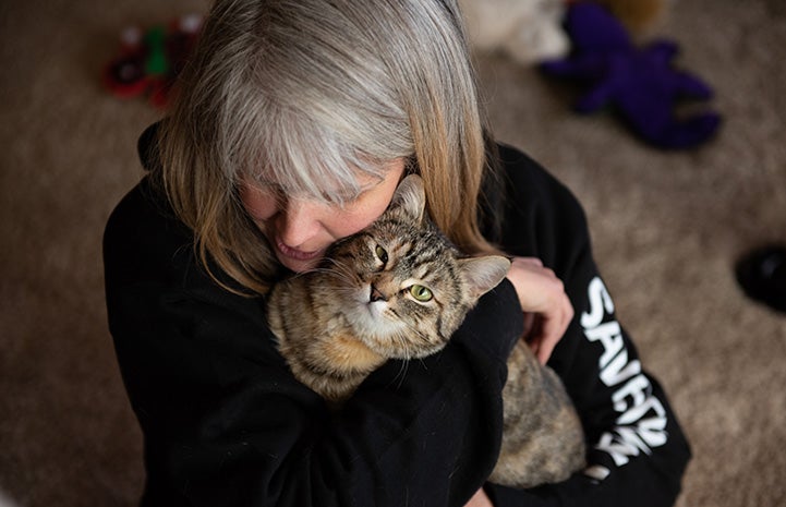 Katherine holding Birdie the cat who she had adopted