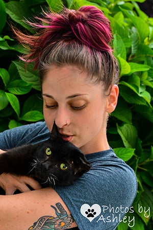 Jade Campbell holding and hugging Duke the cat