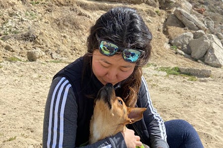 Lizzo the dog and her person snuggling at the beach