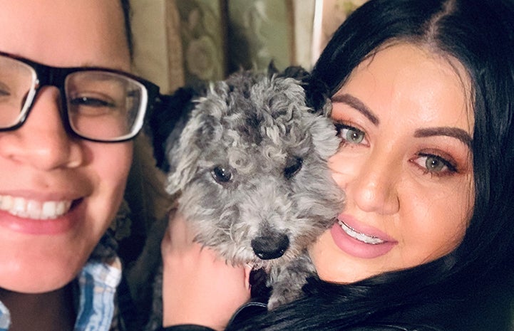 Lil Wayne the puppy being held by two smiling women