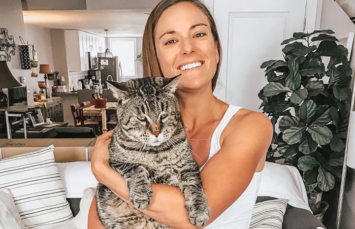 Sarah Bergstein holding Mr. B, the large brown tabby cat