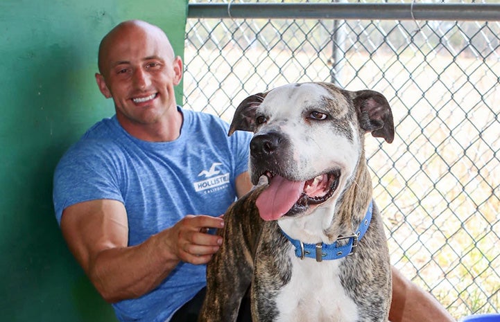 Kris Rotonda with a dog in a kennel together