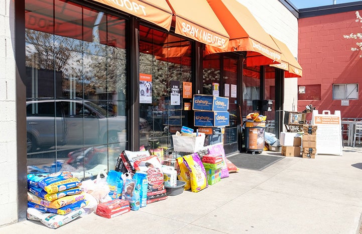 Piles of donated food and supplies placed outside of Best Friends in Salt Lake City