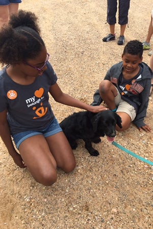 Hana and Kai Walker Pettigrew meet a new canine friend