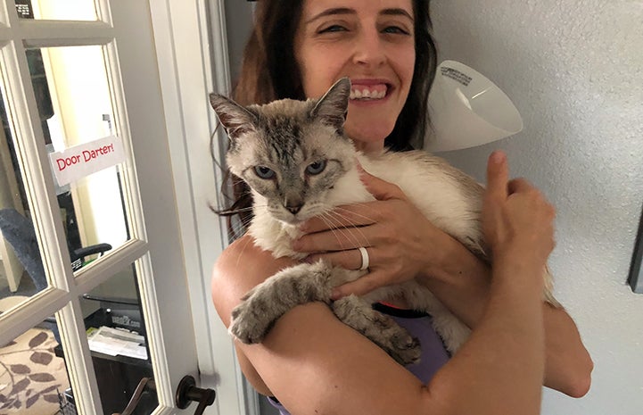 Meghan von Linden holding Knox, the Siamese FIV+ senior cat she adopted