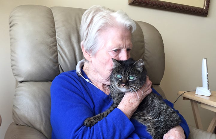 Jan kissing Daisy the senior brown tabby cat