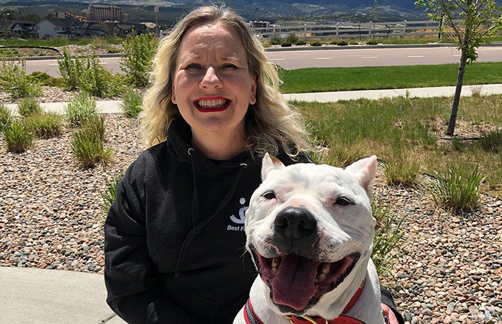 Ralph the dog beside a woman, with both smiling