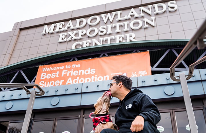 Blue the three-legged dog with Robbie in front of the the Meadowlands Exposition Center for the New York Super Adoption