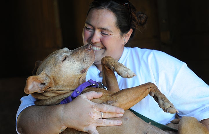 Best Friends caregiver and vet tech Betsy Kidder with Little Red the Vicktory dog