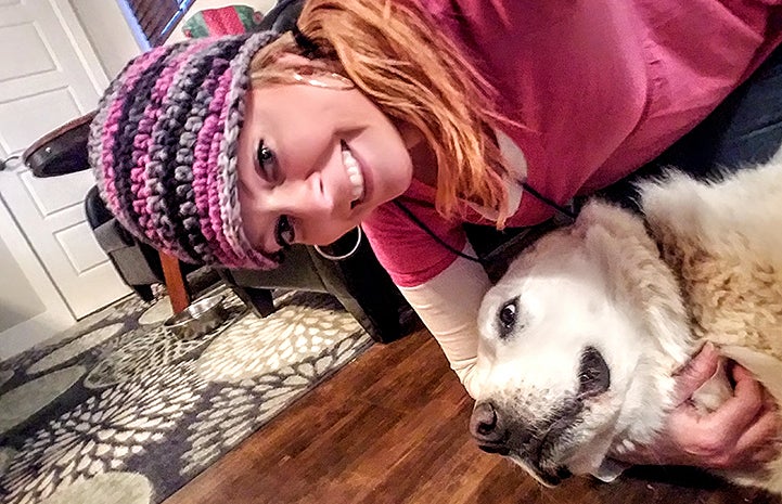 Volunteer Billie Johnson makes a friend with Azeala the dog 