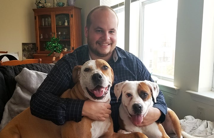 Ron Burd holding his two dogs, Breezy and Luna