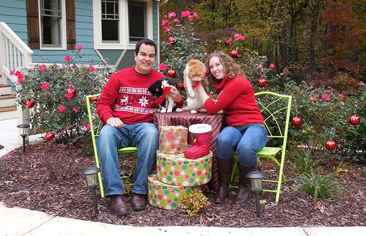 Volunteers Erin and Eric Granados with their cats Smiley and Smuffin