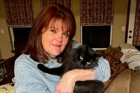 Vicki holding Java the cat