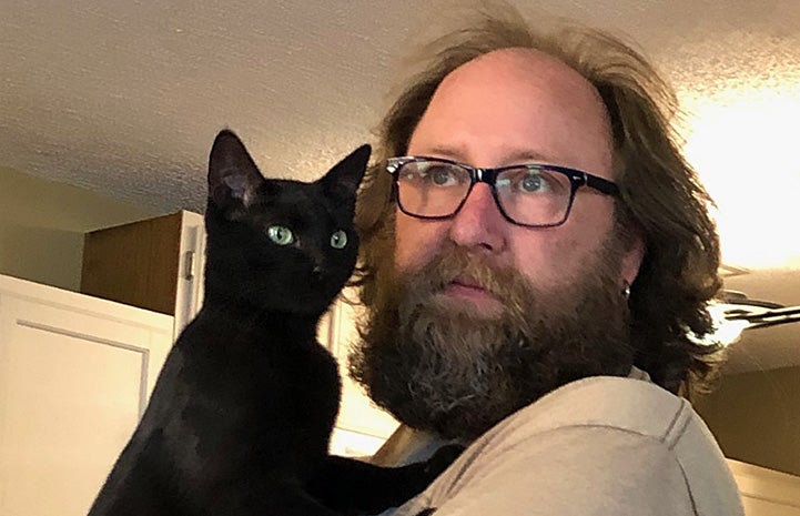 Daniel holding Jordan the black cat