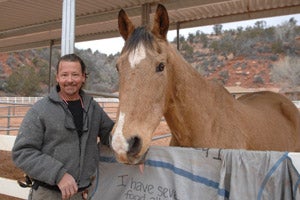 Man and a tan horse