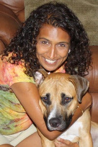 Boxer and bullmastiff mix getting a hug from a girl