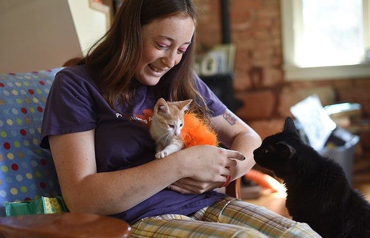 Katie snuggling with Gingersnap the kitten she's fostering