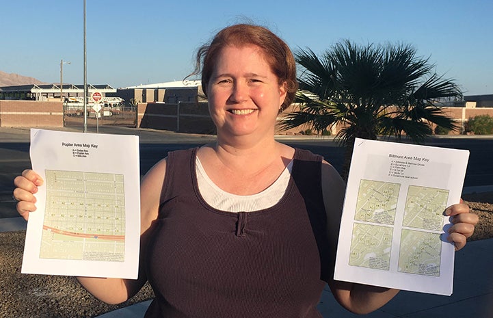 Volunteer Cheryl Collins holding some maps