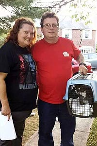 Cricket the cat with her adoptive family