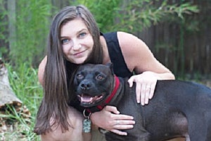 Kaitlyn snuggling with Padfoot the pit bull terrier