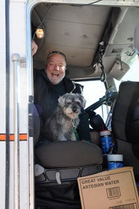 Garrett the dog with Thom in his big rig