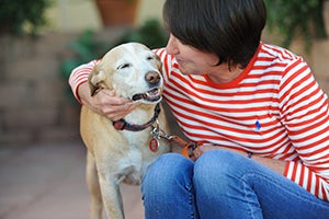 Jennifer Hubbard with her arm around a dog