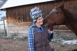 Rocky the horse who has hoof problems with a caregiver