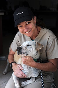 Marshmallow the dog with vet tech Melanie