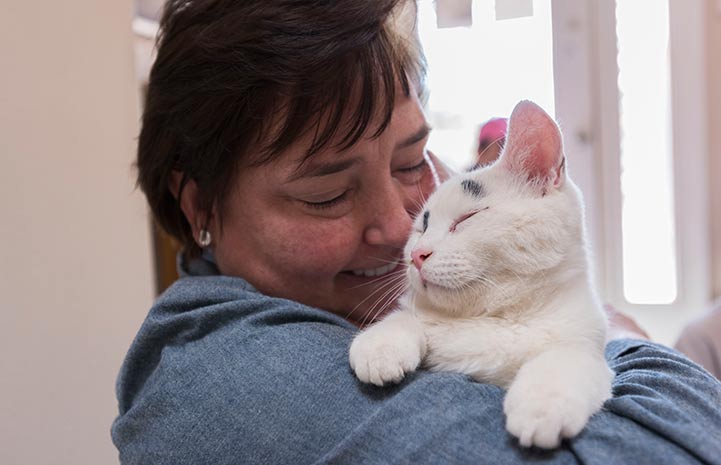 Christina giving Cookie the cat a hug