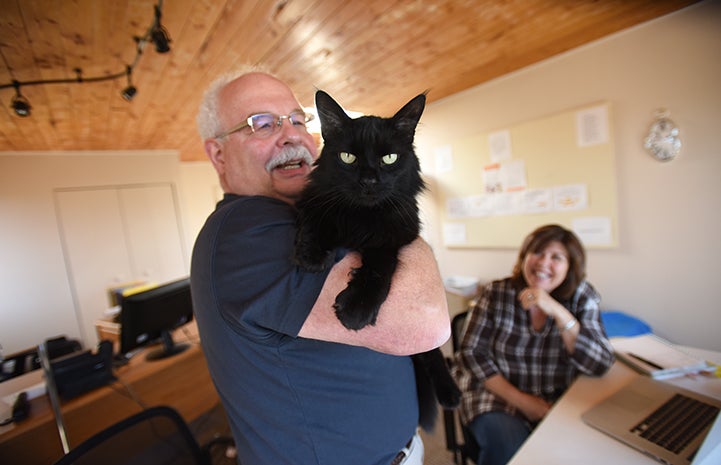 Paul Altherr holding Carmelo the corporate cat