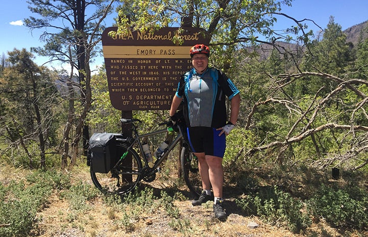 Kevin McCall cycling through a national forest