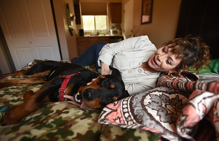 Caryn Rosenthal snuggling with Mac the dog