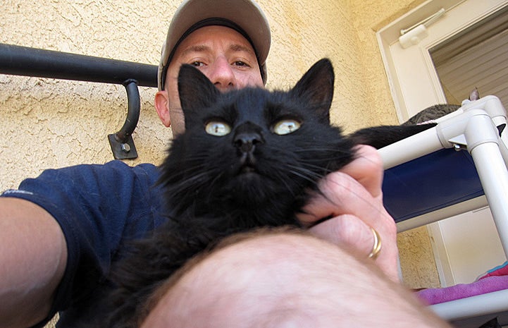 Volunteer Howard Haber with Selma the cat