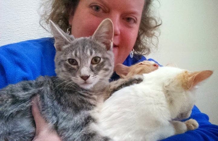 Karin Magnuson holding two cats