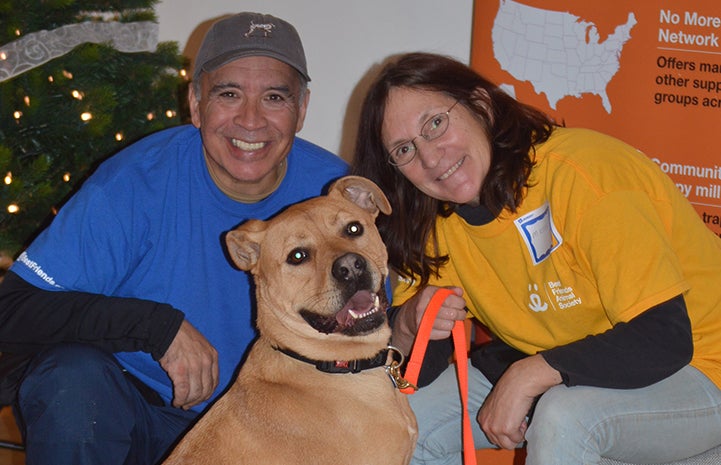 Tyler the dog poses with volunteer Peter Vega